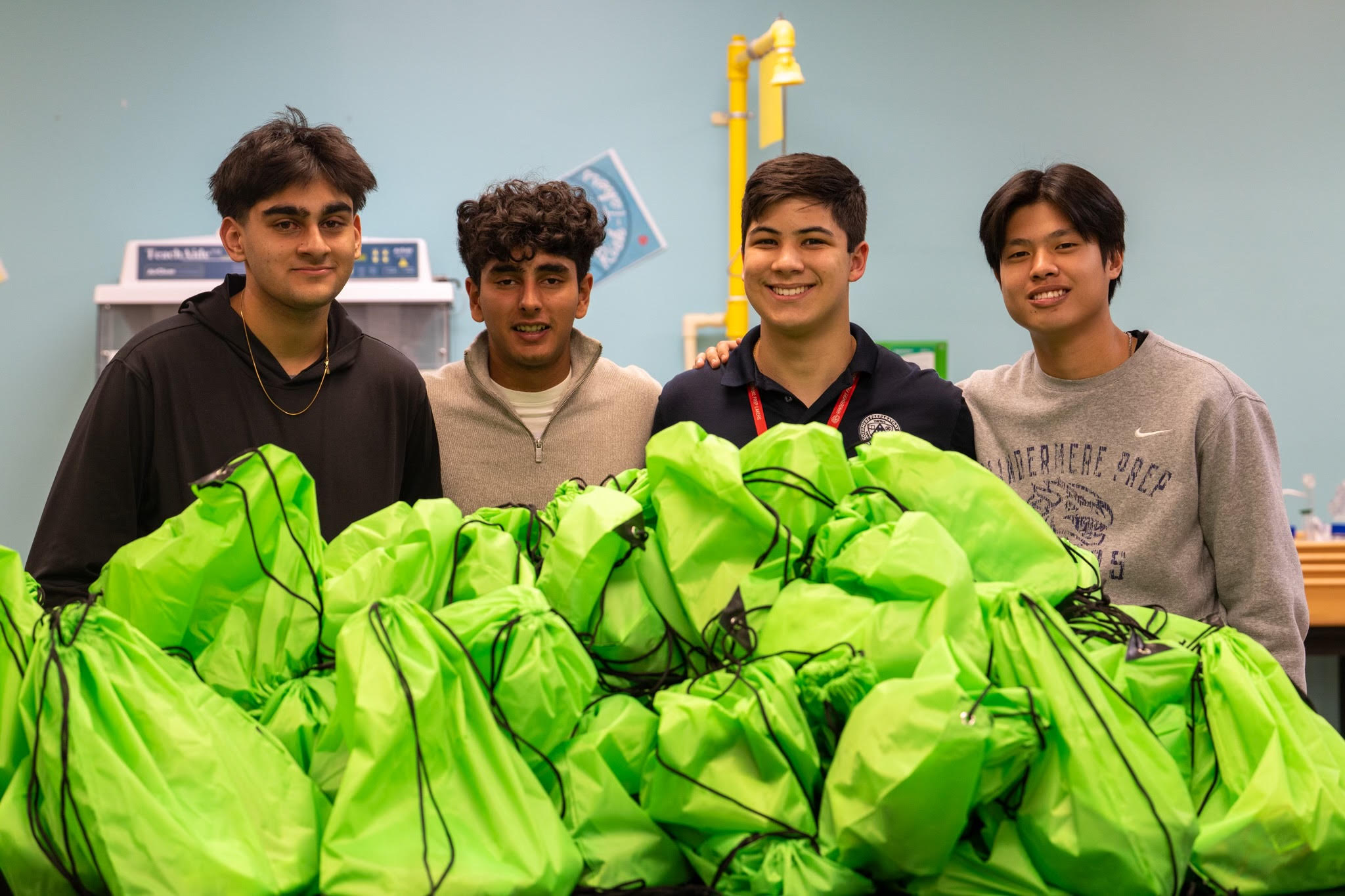Green Guru Project volunteers holding green donation bags on a day of service